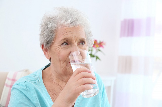 AdobeStock 161990217 Elderly woman drinking water